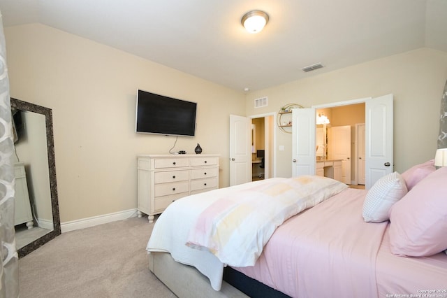 bedroom featuring light carpet, visible vents, baseboards, and lofted ceiling