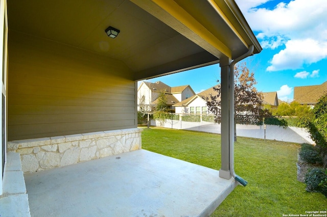 view of patio with fence and a residential view