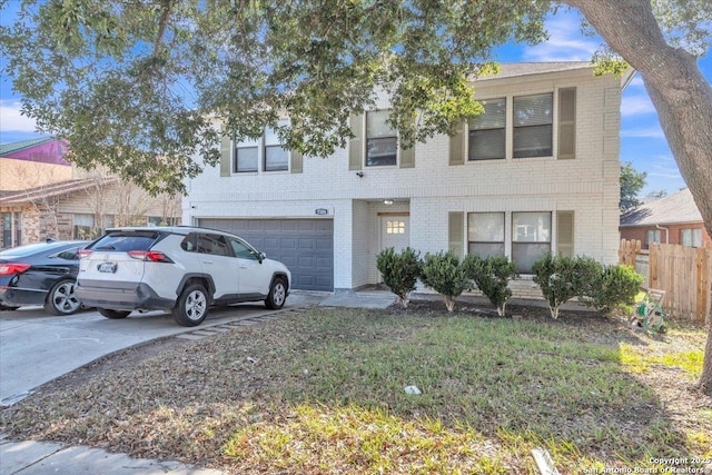 view of front of home featuring brick siding, an attached garage, driveway, and fence