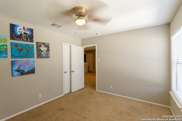7326 Roveen, San Antonio, TX 78244 - unfurnished bedroom with light carpet, visible vents, a ceiling fan, and baseboards