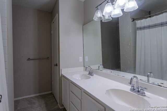 7326 Roveen, San Antonio, TX 78244 - bathroom with a sink, baseboards, double vanity, and tile patterned flooring