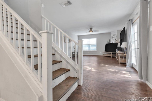 stairway with visible vents, baseboards, ceiling fan, and wood finished floors