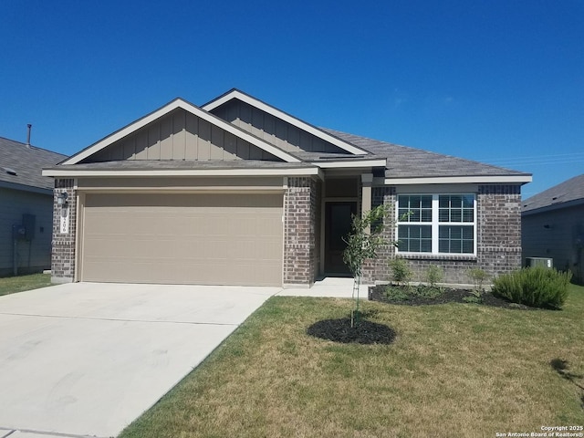 craftsman house with brick siding, board and batten siding, a front lawn, concrete driveway, and a garage