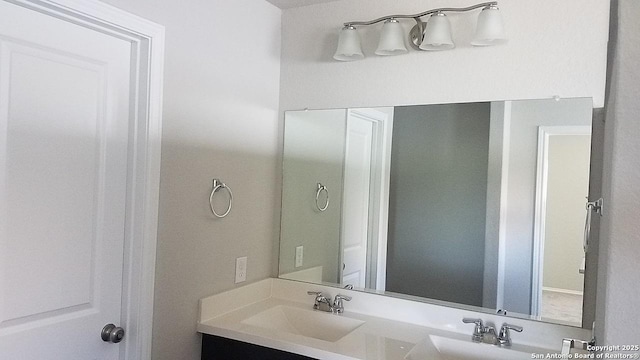 bathroom with a sink and double vanity