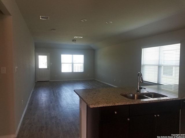 kitchen with dark wood-style flooring, baseboards, visible vents, and a sink