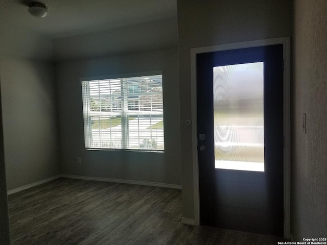 entryway with baseboards and dark wood-style flooring