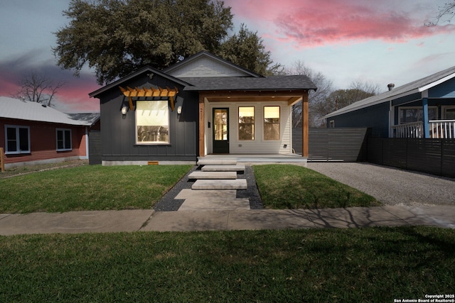 bungalow-style house featuring crawl space, board and batten siding, a front lawn, and a shingled roof