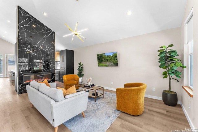 living room with vaulted ceiling, recessed lighting, wood finished floors, and baseboards