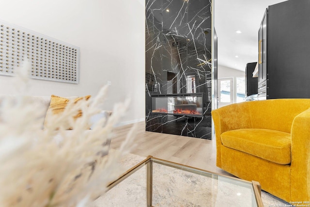 interior space with wood finished floors and a fireplace