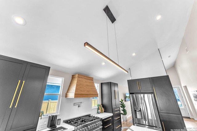 kitchen with premium range hood, light countertops, recessed lighting, appliances with stainless steel finishes, and high vaulted ceiling