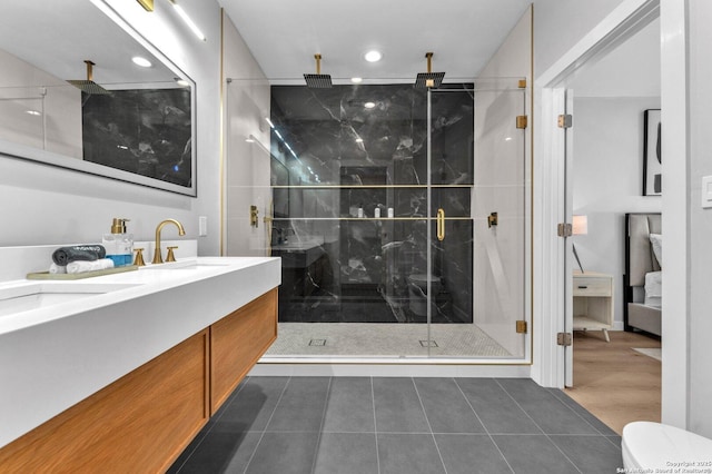 bathroom with a stall shower, a sink, recessed lighting, tile patterned flooring, and double vanity