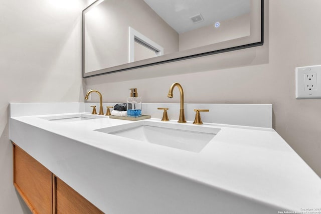 bathroom featuring a sink, visible vents, and double vanity