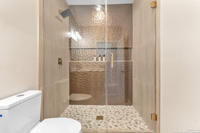 full bathroom featuring toilet and a stall shower