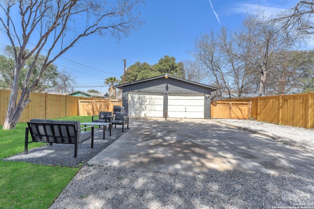 detached garage with a gate and fence