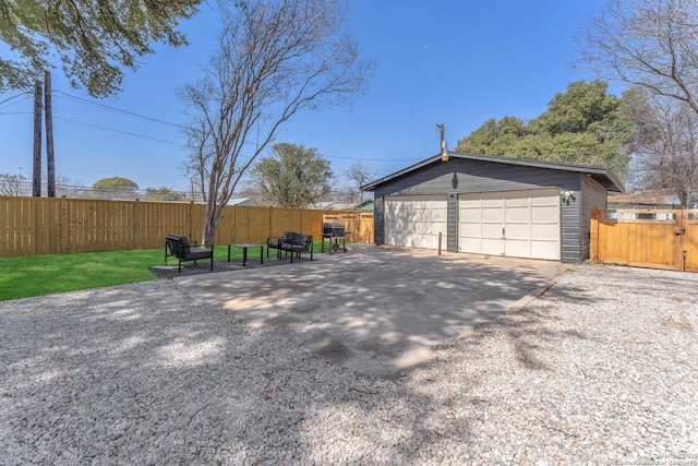 detached garage with fence and driveway