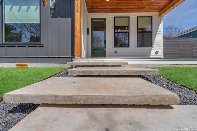 view of exterior entry with board and batten siding