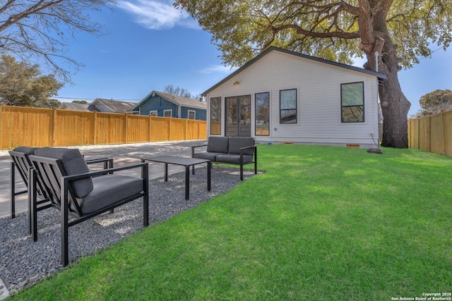 rear view of house with a patio area, a lawn, an outdoor hangout area, a fenced backyard, and crawl space