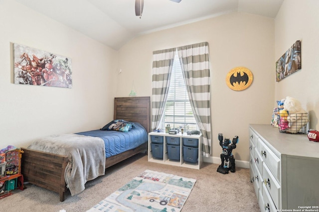 bedroom with vaulted ceiling, light colored carpet, baseboards, and ceiling fan