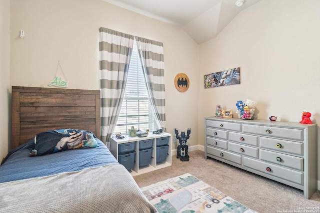 bedroom with vaulted ceiling, light colored carpet, and baseboards