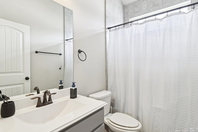 bathroom with vanity, a shower with shower curtain, and toilet