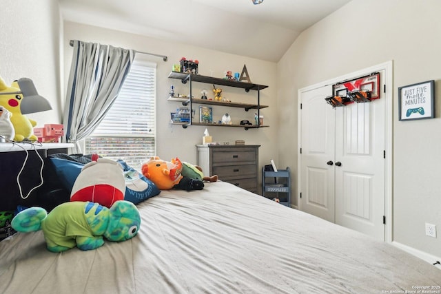 bedroom featuring a closet and lofted ceiling