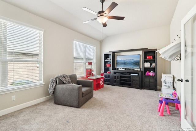 sitting room featuring carpet flooring, baseboards, ceiling fan, and vaulted ceiling