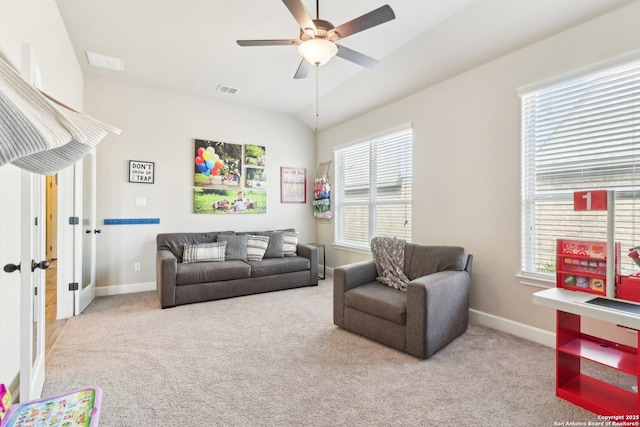 carpeted living room featuring visible vents, lofted ceiling, baseboards, and ceiling fan