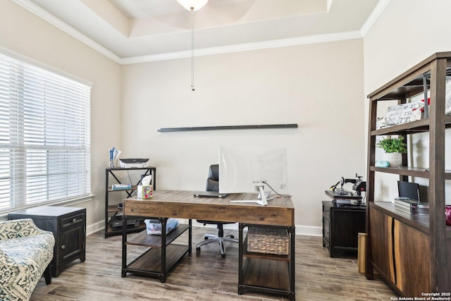 office featuring a ceiling fan, baseboards, wood tiled floor, a tray ceiling, and ornamental molding