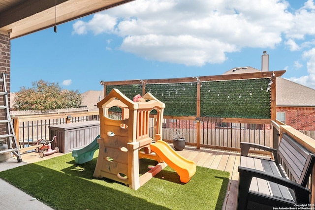 view of playground featuring fence