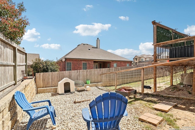 view of yard featuring an outdoor fire pit and a fenced backyard