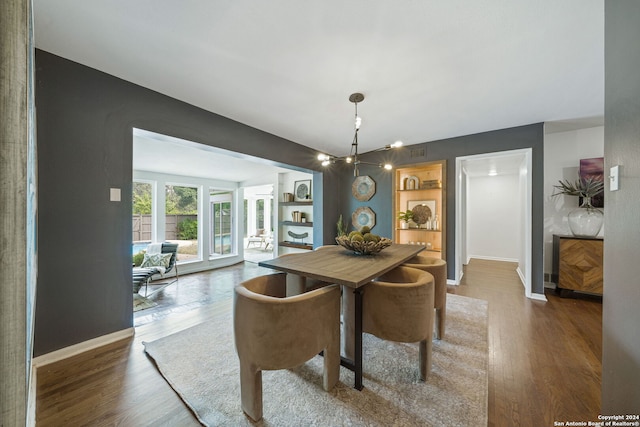 dining area with visible vents, baseboards, and wood finished floors