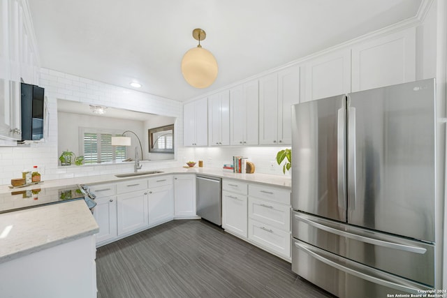 kitchen with white cabinets, tasteful backsplash, appliances with stainless steel finishes, and a sink