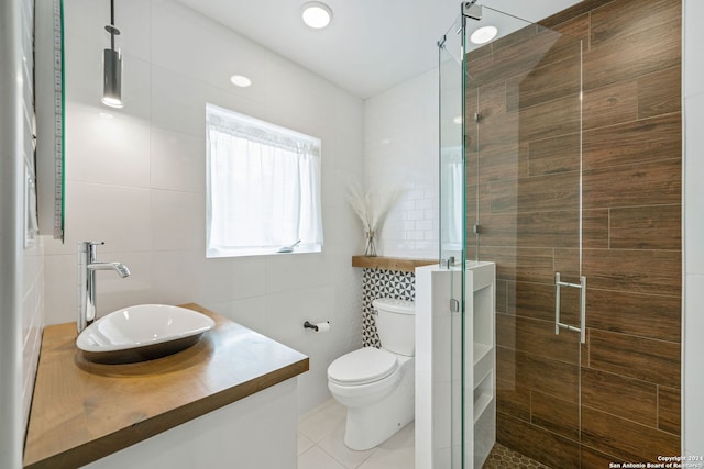 bathroom with vanity, tile walls, and a shower stall