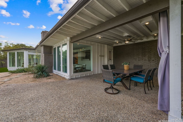 view of patio / terrace featuring outdoor dining space and a sunroom