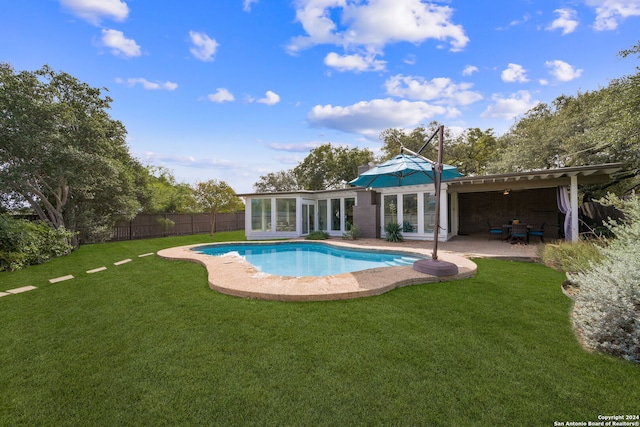 view of pool featuring a patio area, a lawn, a fenced backyard, and a fenced in pool