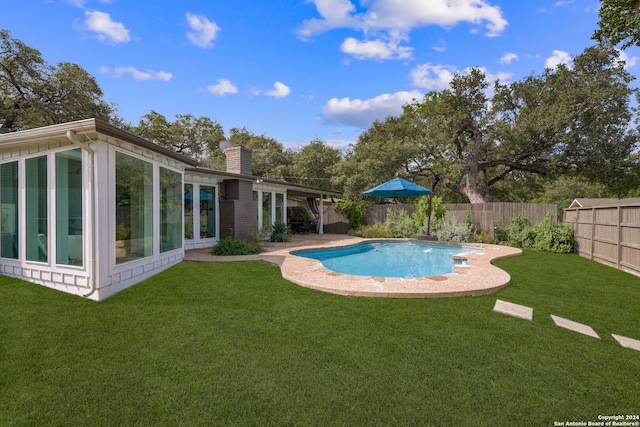 view of swimming pool featuring a yard, a fenced in pool, and a fenced backyard