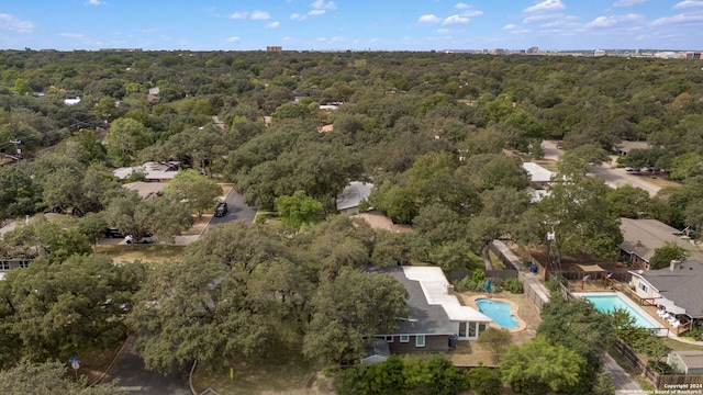 drone / aerial view with a wooded view