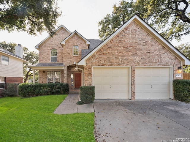 traditional-style home with brick siding, a garage, driveway, and a front lawn