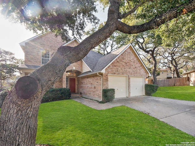 view of front facade with driveway, fence, a front yard, a garage, and brick siding