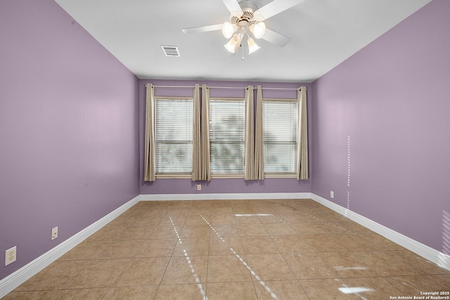 spare room featuring visible vents, plenty of natural light, and baseboards