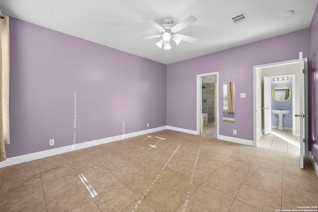 tiled spare room with a sink, baseboards, visible vents, and ceiling fan