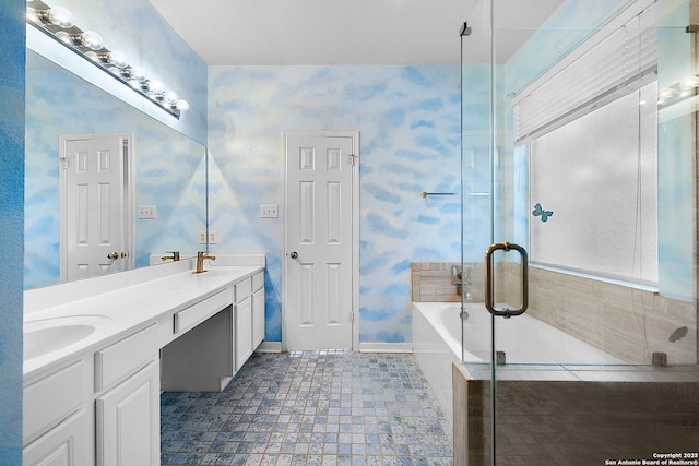 full bath featuring a sink, wallpapered walls, double vanity, and a washtub