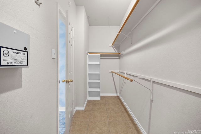 spacious closet featuring light tile patterned floors