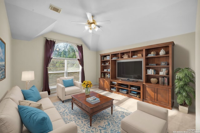 living room with visible vents, lofted ceiling, light carpet, and a ceiling fan