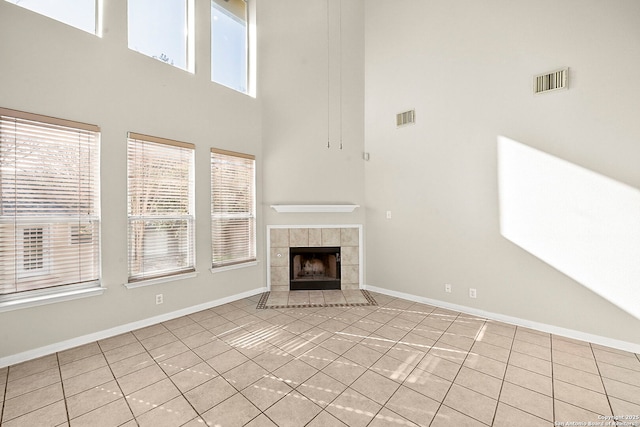 unfurnished living room featuring tile patterned floors, baseboards, and visible vents