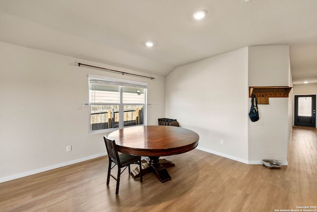 dining area with lofted ceiling, recessed lighting, baseboards, and light wood-type flooring