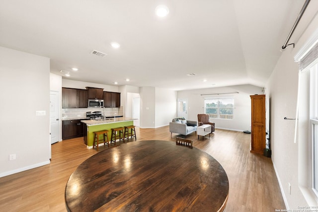 dining room with recessed lighting, visible vents, baseboards, and light wood-style flooring