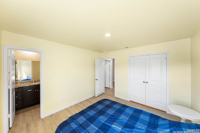 unfurnished bedroom with visible vents, baseboards, light wood-type flooring, ensuite bathroom, and a closet