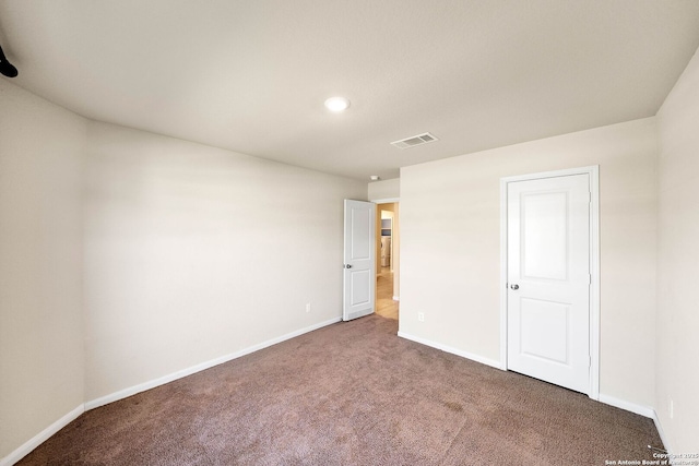 unfurnished bedroom with visible vents, baseboards, and carpet floors