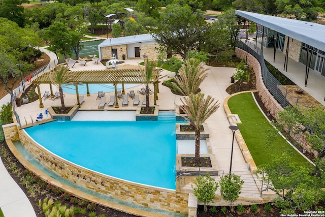 community pool with a patio and fence